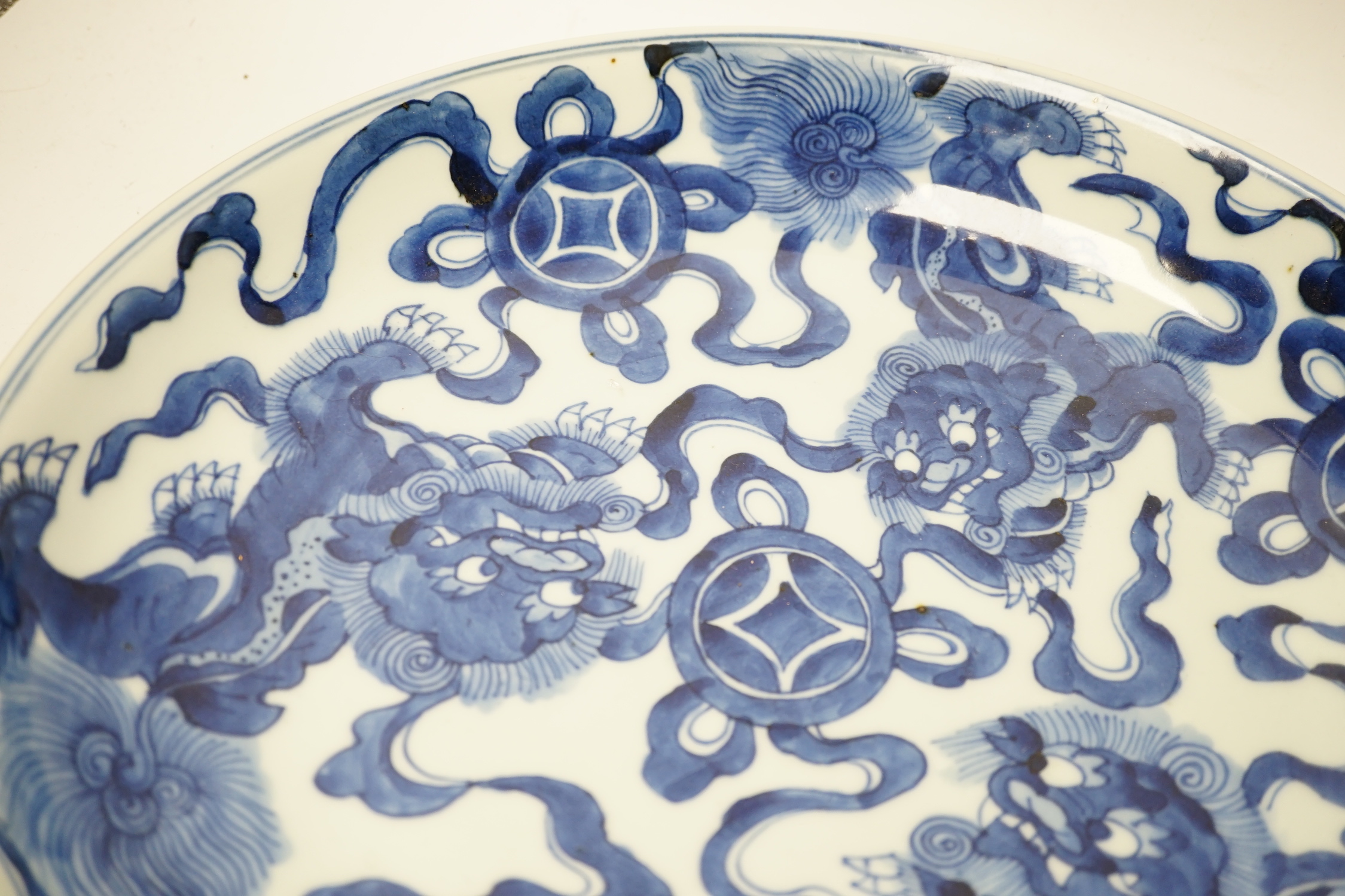 A Chinese blue and white ‘Buddhist lion’ dish, channel moulded foot, 36cm diameter